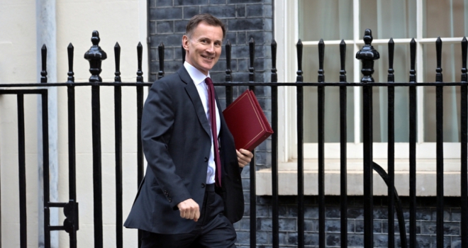 jeremy hunt looking pleased with a briefcase