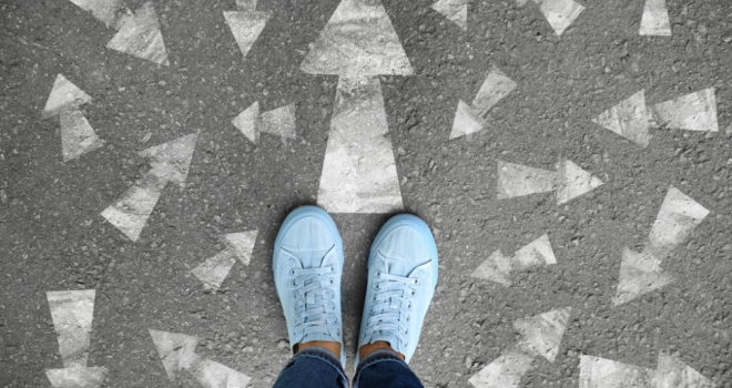 Shifting customer needs and adviser behaviour: a post-budget analysis pair of feet in blue trainers standing on pavement with chalk arrows in different directions