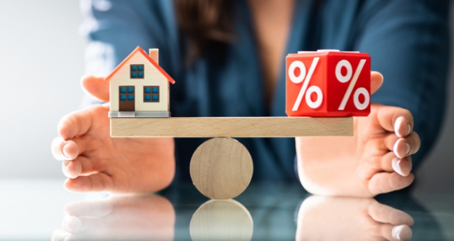 Mortgage costs balancing scales with a house and a percentage sign