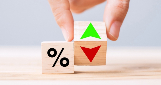 Mortgage approvals on track for spring recovery before Iran war: BoE hand changing wooden cubes with up and down arrows