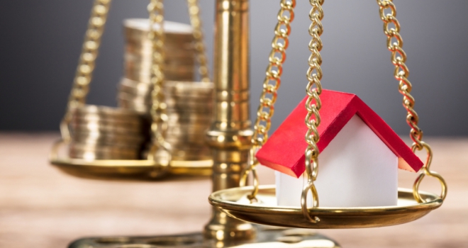 Mortgage affordability at tightest level since 2008: UK Finance pound coins money scales balance house prices