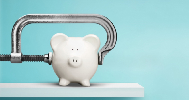 Stamp duty change to result in 'double whammy' hit for first-time buyers piggy bank in a vice