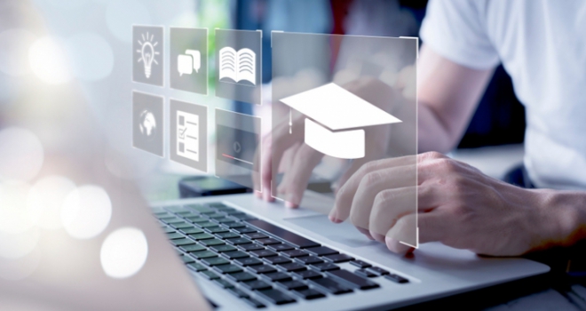 Quilter Financial Adviser School rebrands to focus on post-qualification training man using a computer to learn online