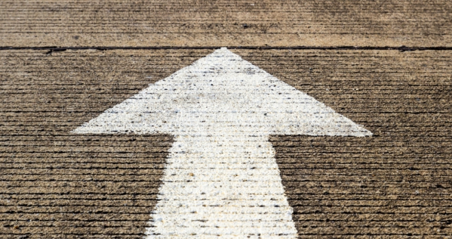 Bank of England raises interest rates to 1.0% white arrow painted on concrete