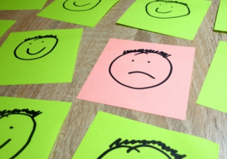 91% of brokers anticipate business growth in 2025 happy sad faces paper up down positive negative
