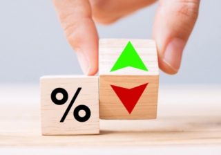 Second charge lending up 24% in January hand changing wooden cubes with up and down arrows