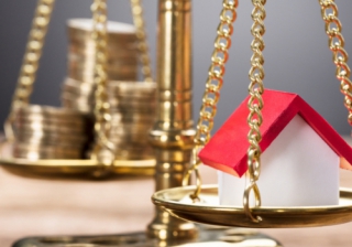 House price to earnings ratio at lowest level in over a decade: Nationwide pound coins money scales balance house prices