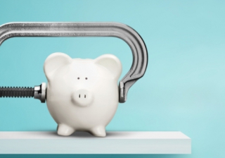 Stamp duty change to result in 'double whammy' hit for first-time buyers piggy bank in a vice