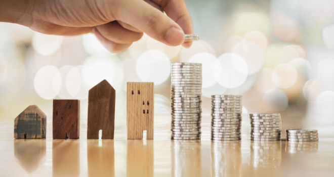 Buy-to-let affordability - challenges and opportunities small wooden houses next to piles of coins