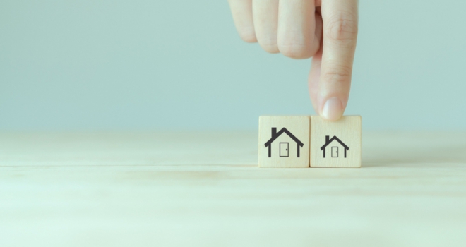 Which areas are the best and worst for downsizers? two wooden blocks depicting houses with a hand picking up the block witha smaller house to indicate downsizing