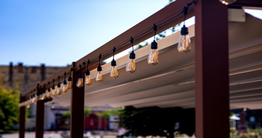 Increasing revenue through permitted development textile awning in city street cafe wooden frame gazebo