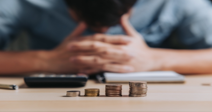 Rental revenues lost by landlords due to void periods has increased by 19% across England Person sat in front of money on a table