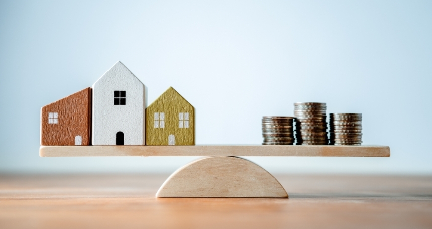 Just 2% of landlords have confidence in the UK economy: NRLA a house and coins balance on either end of a scale
