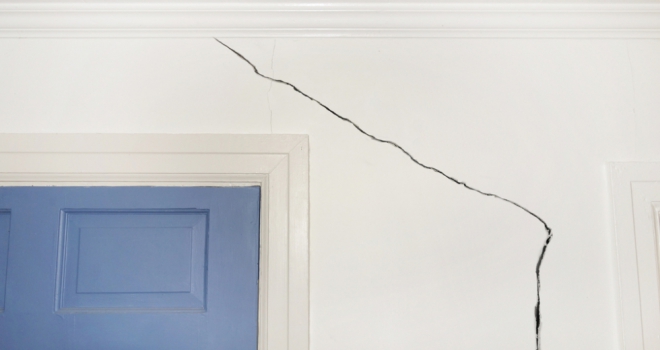 Landlord insurance claims for malicious damage rise 50% during pandemic crack in white wall over blue door