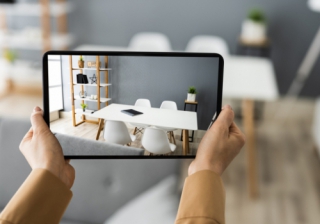 Homes being marketed with no photos in 'rush' to list property pair of hands holding a tablet taking photo of dining room